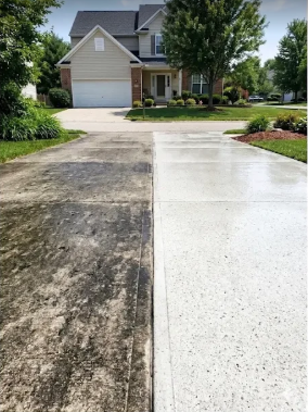 Driveway showing dirty and cleaned concrete side by side