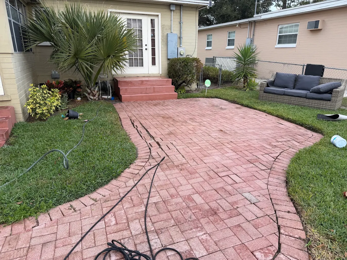 Brick paver patio ready for pressure washing at a Central Florida home